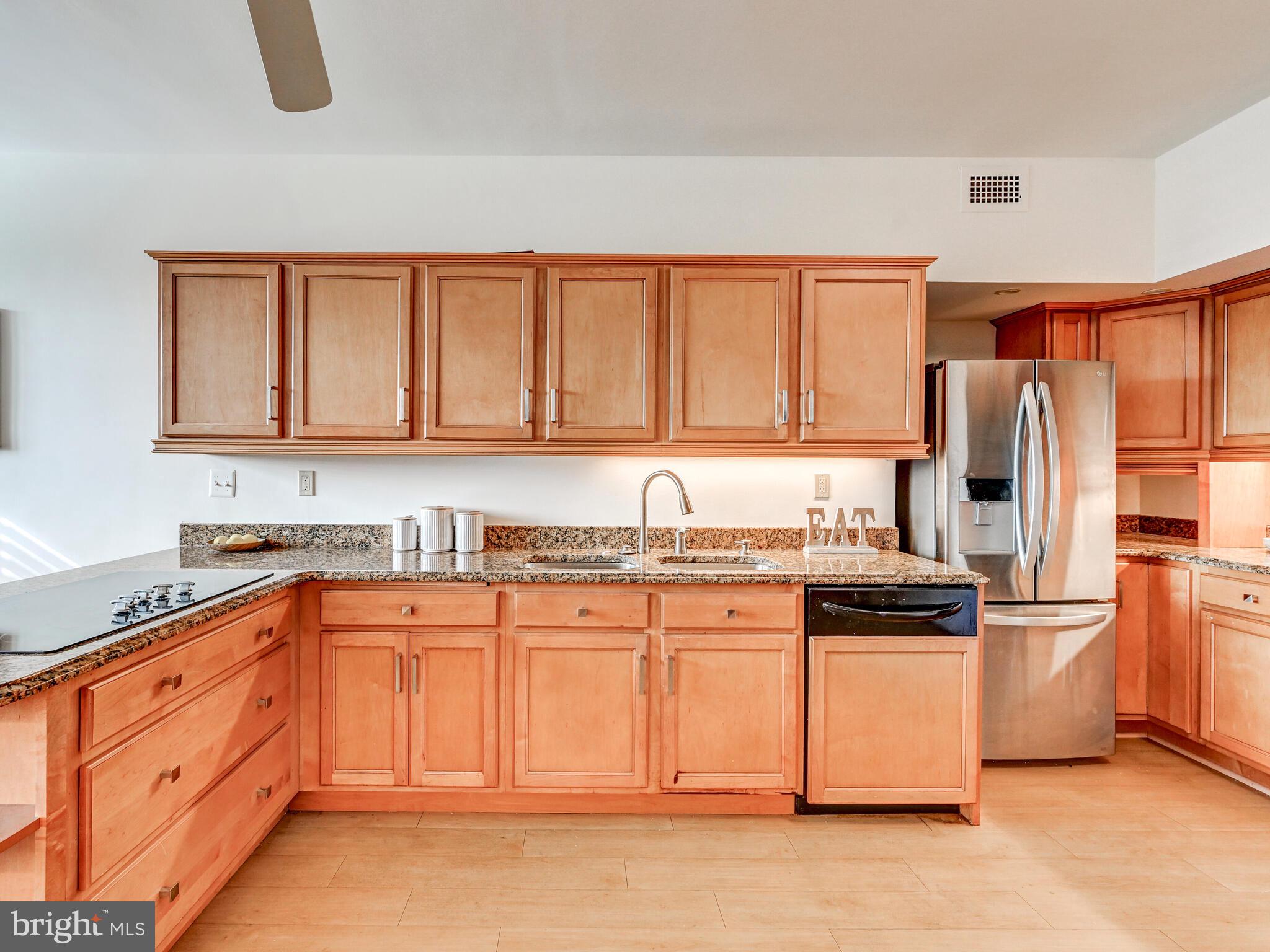 11 Slade Avenue, Unit 912 Baltimore, MD 21208 - Photo 14 of 31 a kitchen with stainless steel appliances granite countertop a stove a sink dishwasher and a refrigerator