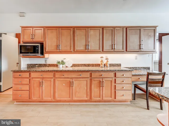 a kitchen with stainless steel appliances granite countertop a stove sink and cabinets