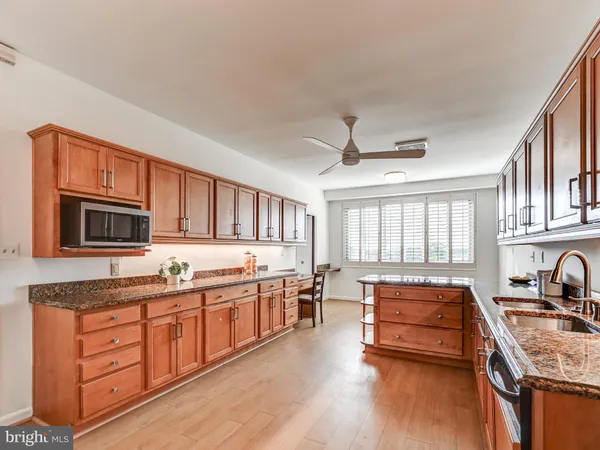 a kitchen with granite countertop stainless steel appliances and counter space