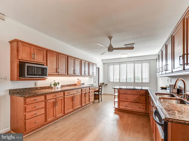 a kitchen with granite countertop stainless steel appliances and counter space