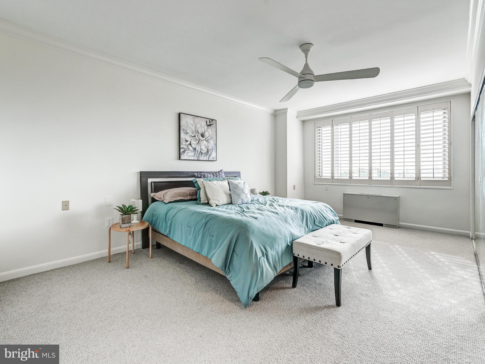 11 Slade Avenue, Unit 912 Baltimore, MD 21208 - Photo 19 of 31 a bedroom with a bed and a table in it