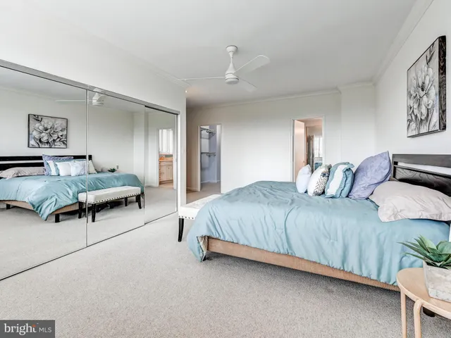 a spacious bathroom with a granite countertop sink and a large mirror