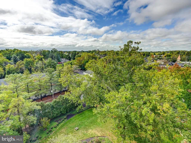 a living room with furniture large window and glass table