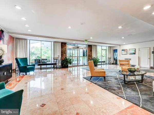 a view of yellow house with a big yard and potted plants and large trees