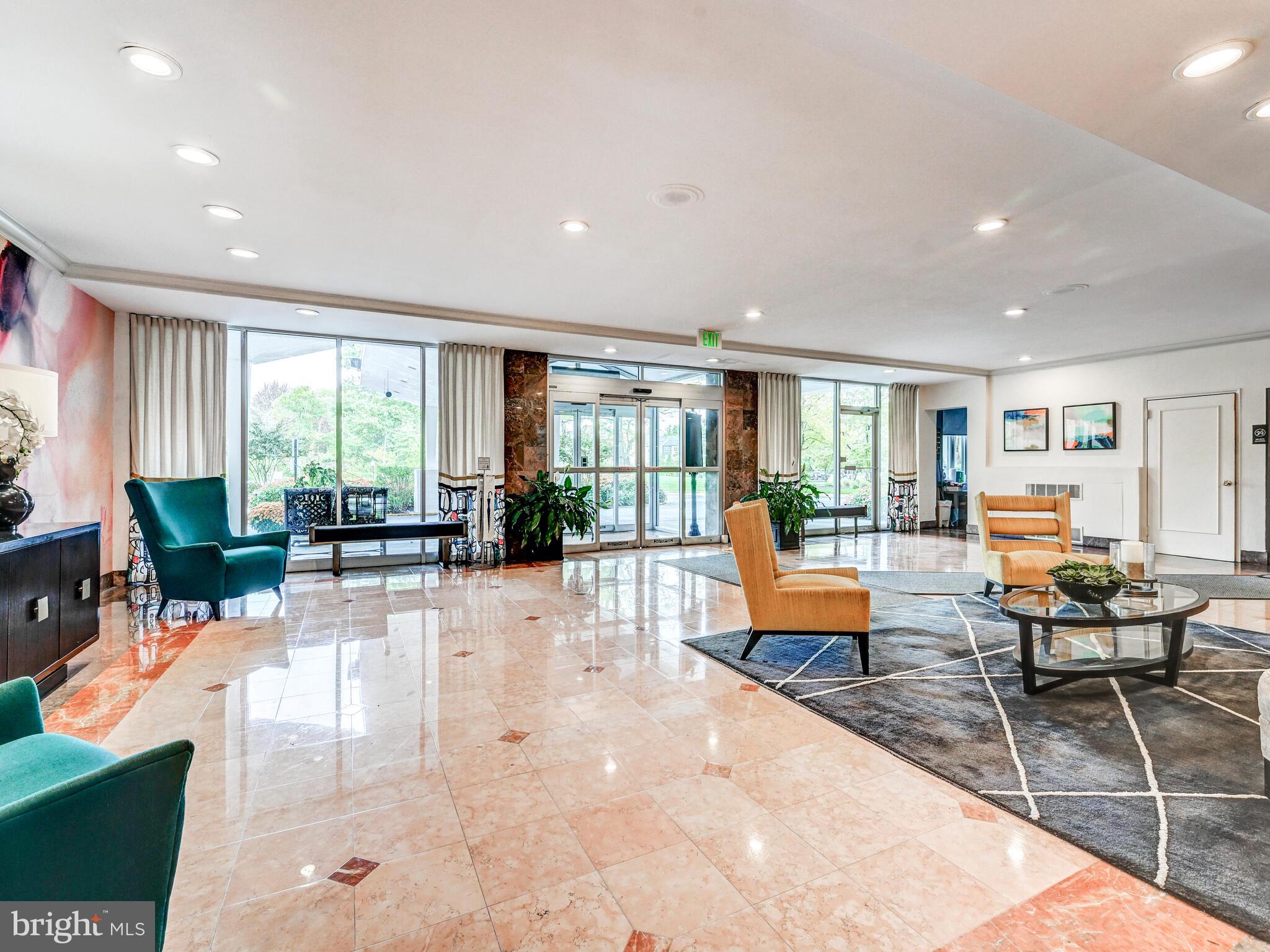 11 Slade Avenue, Unit 912 Baltimore, MD 21208 - Photo 30 of 31 a living room with furniture large window and glass table