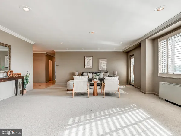 a living room with furniture a dining table and a large window