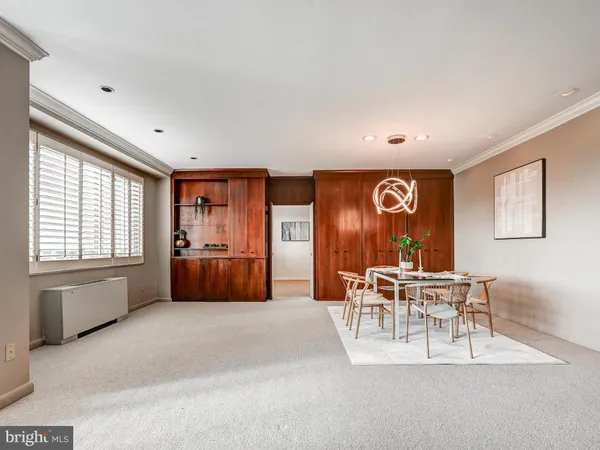 a living room with furniture a dining table and chairs