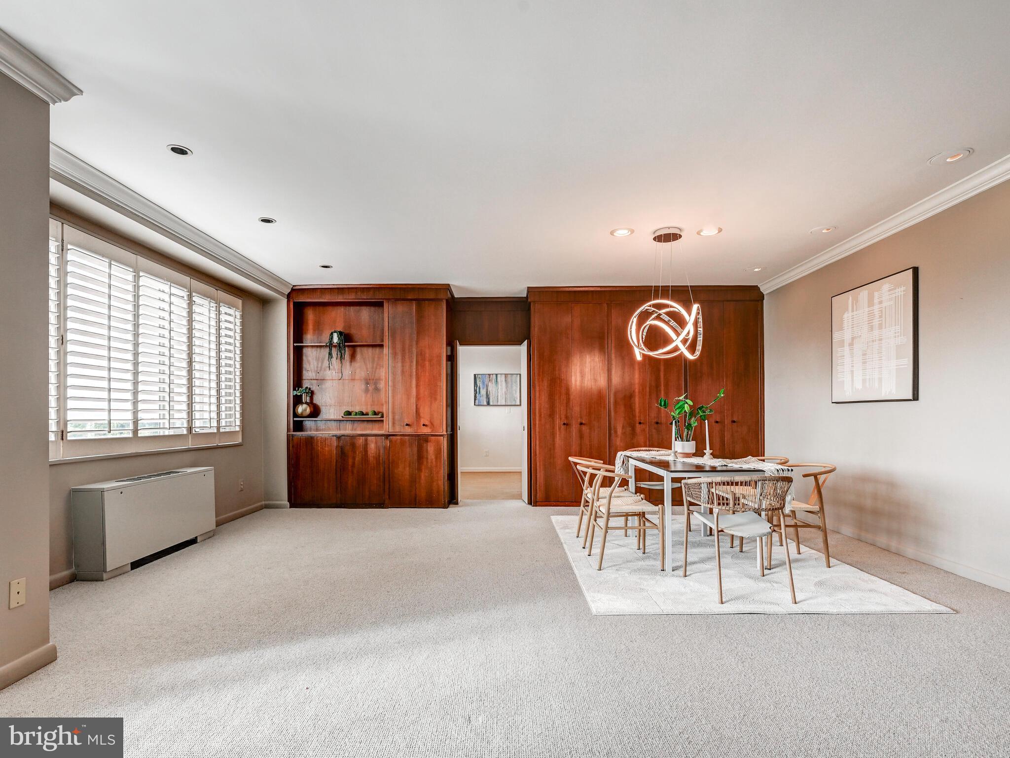 11 Slade Avenue, Unit 912 Baltimore, MD 21208 - Photo 7 of 31 a living room with furniture a dining table and a large window