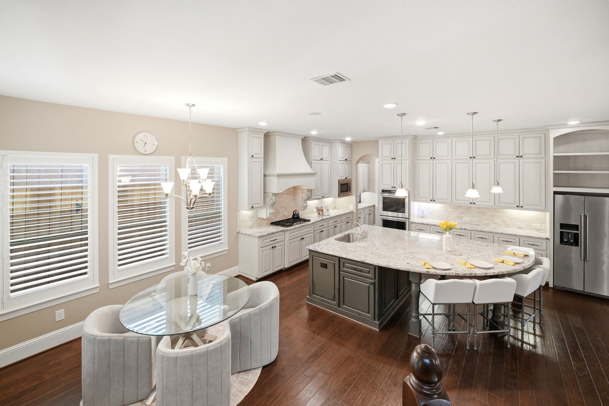 5815 Stratton Woods Drive Spring, TX 77389 - Photo 20 of 45 a kitchen with a dining table chairs and white cabinets
