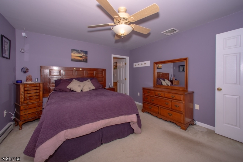 5 Twin Pond Road Montague, NJ 07827 - Photo 13 of 29 a bedroom with a bed and a chandelier