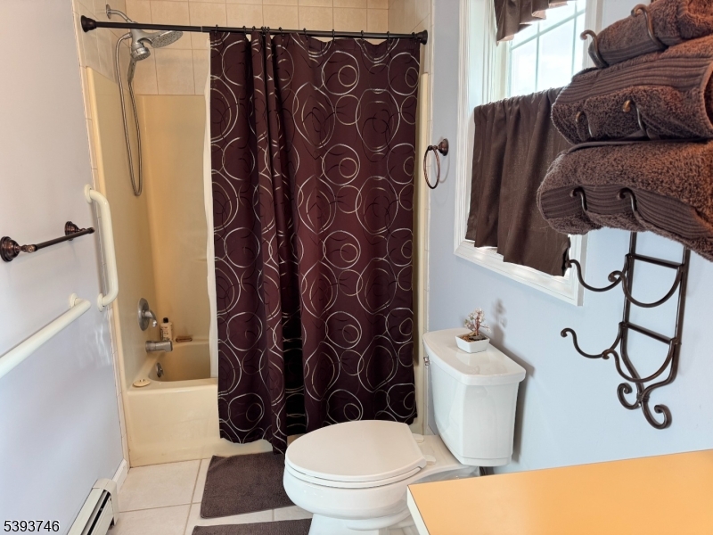 5 Twin Pond Road Montague, NJ 07827 - Photo 15 of 29 a bathroom with a toilet and a shower curtain