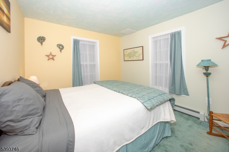 5 Twin Pond Road Montague, NJ 07827 - Photo 16 of 29 a bedroom with a bed and a painting on the wall