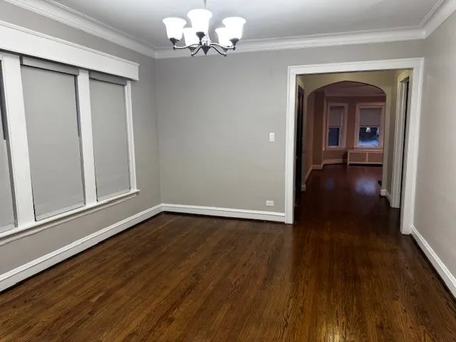 a view of a livingroom with wooden floor and a ceiling fan