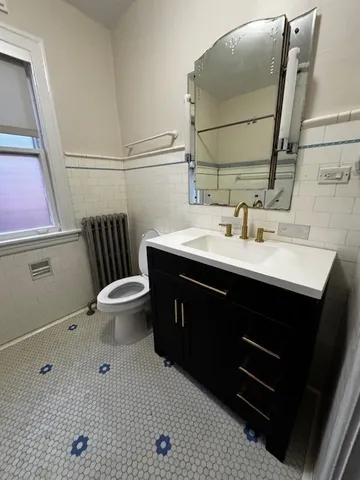 a bathroom with a sink toilet and mirror