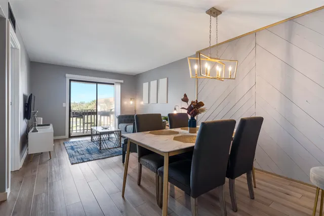 a view of a dining room with furniture window and wooden floor
