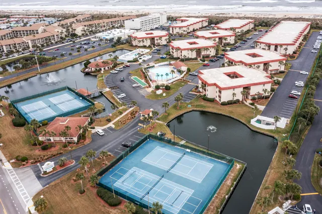 an aerial view of a residential houses with outdoor space