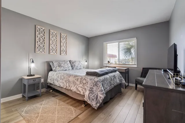 a bedroom with a bed and a flat screen tv