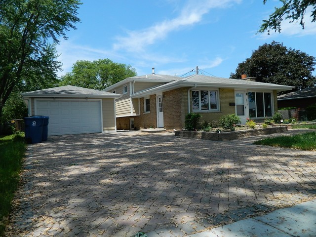15210 Ridgeway Avenue Midlothian, IL 60445 - Photo 1 of 19 a front view of a house with garden
