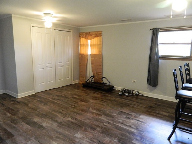 15210 Ridgeway Avenue Midlothian, IL 60445 - Photo 17 of 19 a view of a room with gym equipment and windows