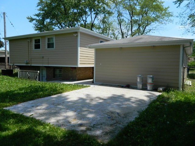 15210 Ridgeway Avenue Midlothian, IL 60445 - Photo 19 of 19 a front view of a house with a yard and garage