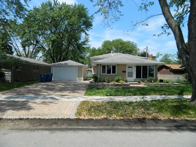 15210 Ridgeway Avenue Midlothian, IL 60445 - Photo 2 of 19 a front view of a house with a yard tree and outdoor seating