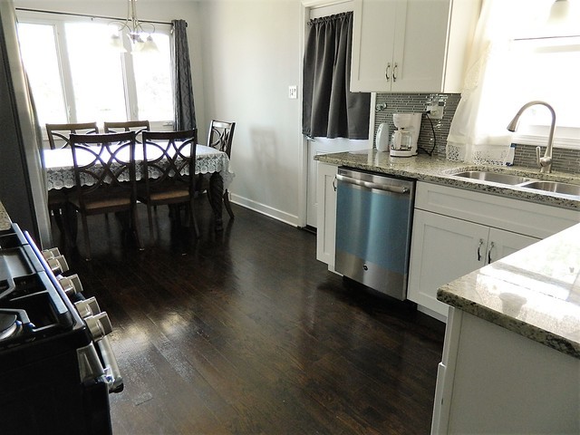 15210 Ridgeway Avenue Midlothian, IL 60445 - Photo 6 of 19 a kitchen with granite countertop a stove a sink dishwasher and a refrigerator with wooden floor