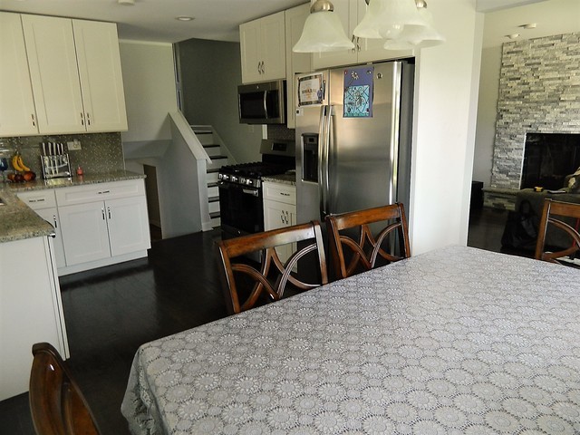 15210 Ridgeway Avenue Midlothian, IL 60445 - Photo 7 of 19 a kitchen with stainless steel appliances kitchen island granite countertop a refrigerator a stove top oven a sink dishwasher and wooden floor