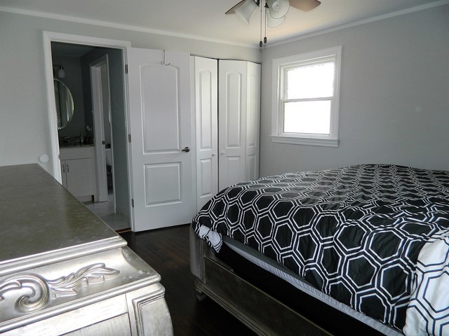 15210 Ridgeway Avenue Midlothian, IL 60445 - Photo 9 of 19 a bed sitting in a bedroom next to a window and a chandelier