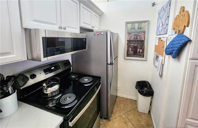 a view of a dining room with furniture and a chandelier fan