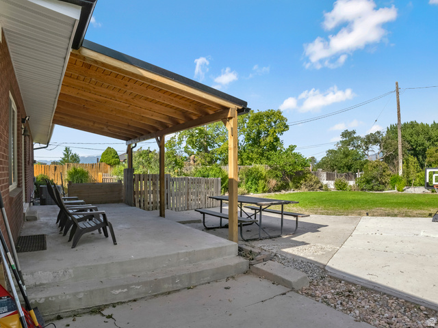 523 South Main Street Payson, UT 84651 - Photo 35 of 41 Covered patio with a natural wood ceiling, concrete flooring, and brick exterior
