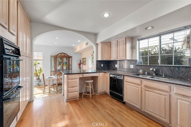 a kitchen with sink cabinets and wooden floor