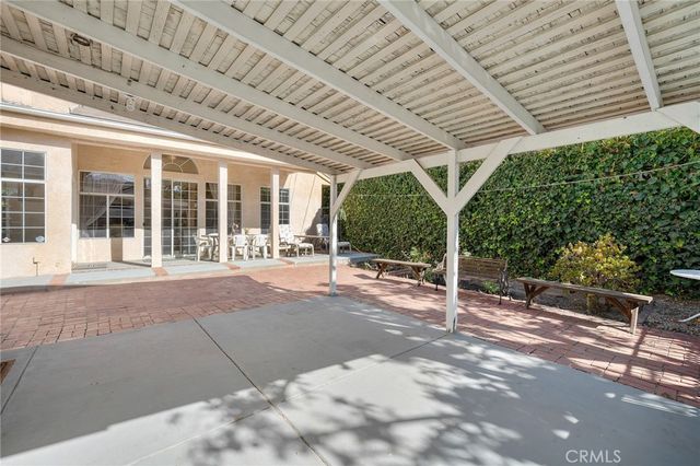 a view of a swimming pool with outdoor seating and plants