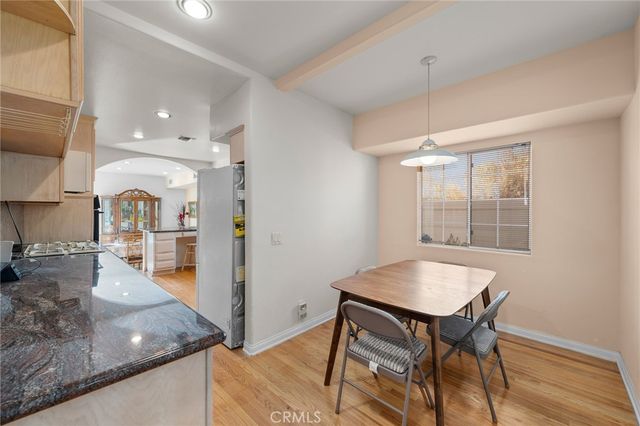 a view of a kitchen with kitchen island a dining table chairs and chandelier