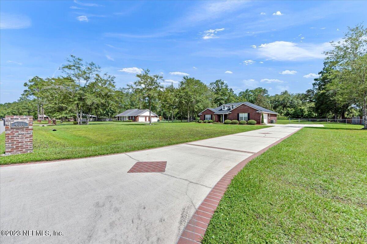 4616 Estates Street Macclenny, FL 32063 - Photo 2 of 32 a view of a house with a big yard