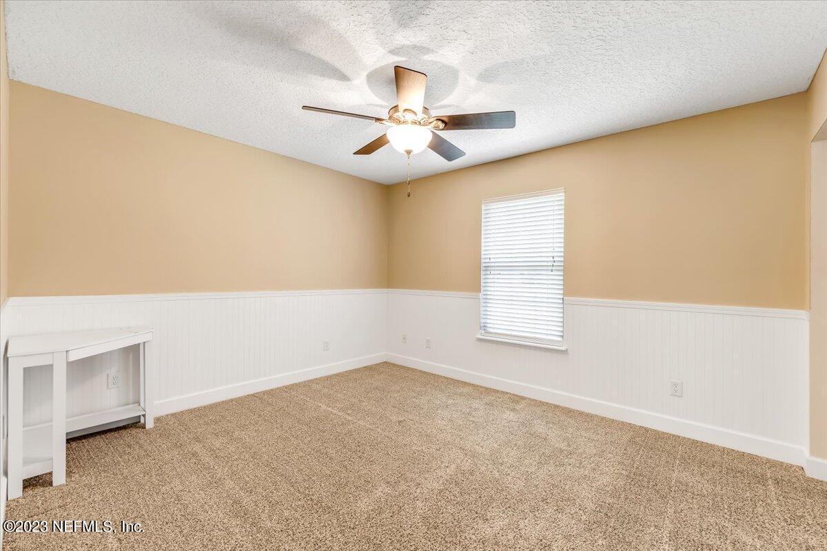 4616 Estates Street Macclenny, FL 32063 - Photo 22 of 32 an empty room with windows and fan