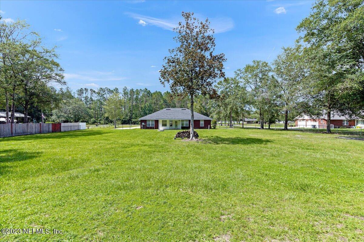 4616 Estates Street Macclenny, FL 32063 - Photo 30 of 32 a view of a house with a big yard