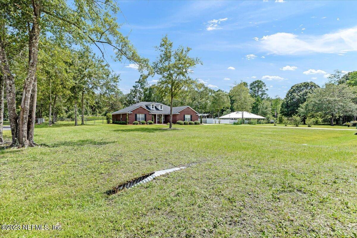 4616 Estates Street Macclenny, FL 32063 - Photo 3 of 32 a view of yard with tree and green space