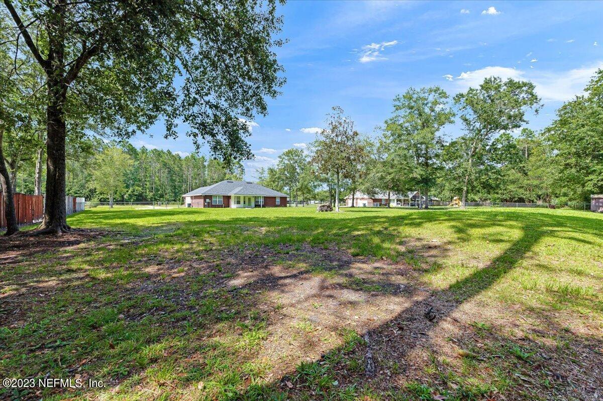 4616 Estates Street Macclenny, FL 32063 - Photo 31 of 32 a view of a golf course with a big yard