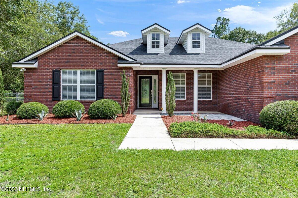 4616 Estates Street Macclenny, FL 32063 - Photo 4 of 32 a front view of a house with garden
