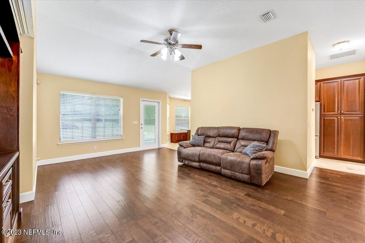 4616 Estates Street Macclenny, FL 32063 - Photo 6 of 32 a living room with furniture and a chandelier
