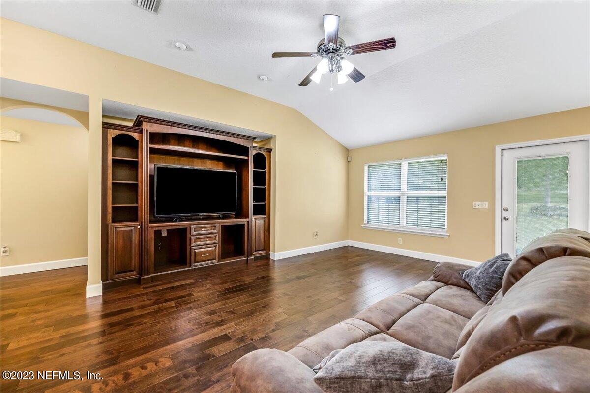 4616 Estates Street Macclenny, FL 32063 - Photo 7 of 32 a living room with furniture and a flat screen tv
