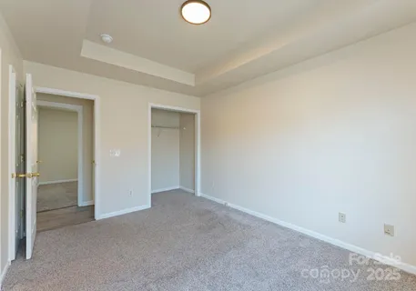a view of an empty room and closet area