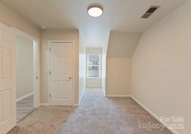an empty room with closet and windows