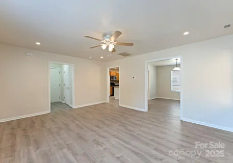 a view of an empty room with a ceiling fan