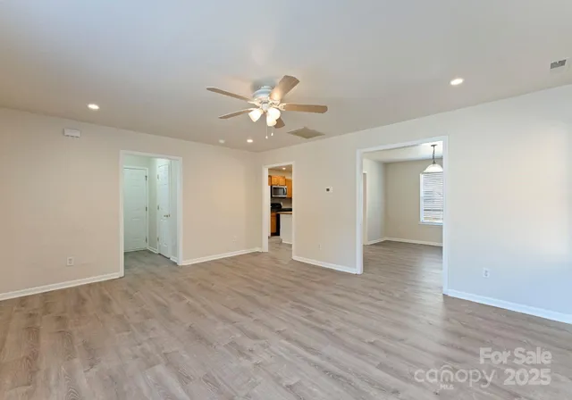 a view of an empty room with a ceiling fan