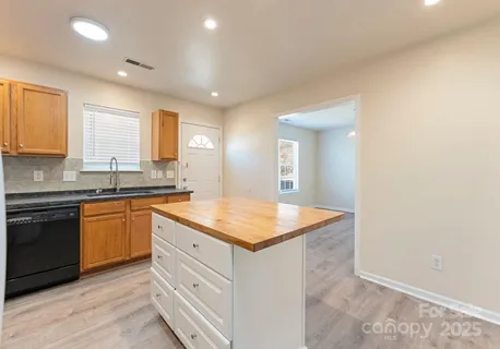 a kitchen with granite countertop white cabinets and white appliances
