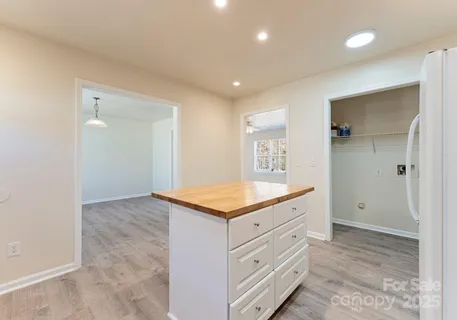 a room with a granite countertop sink and a mirror