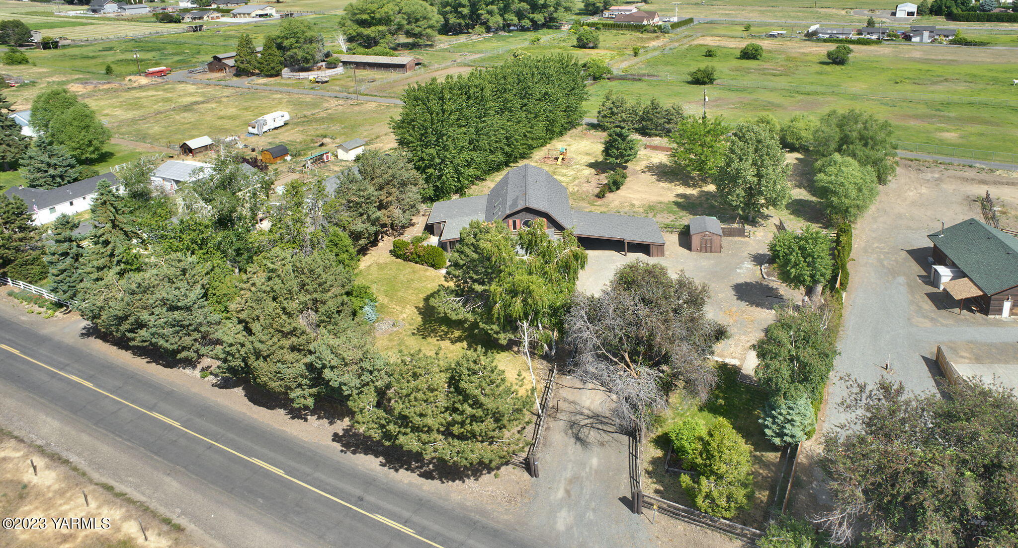 7903 Meadowbrook Road Yakima, WA 98903 - Photo 3 of 32 an aerial view of a house with a yard and greenery