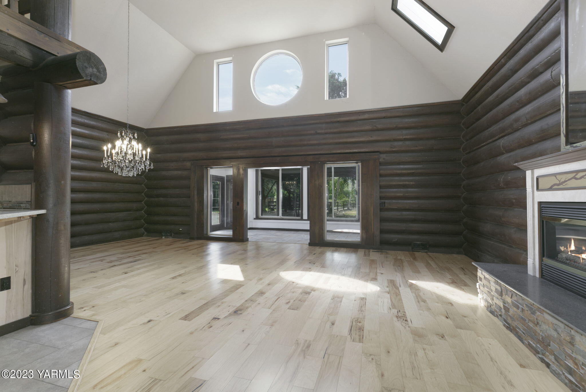 7903 Meadowbrook Road Yakima, WA 98903 - Photo 8 of 32 a view of an empty room with wooden floor and a fireplace