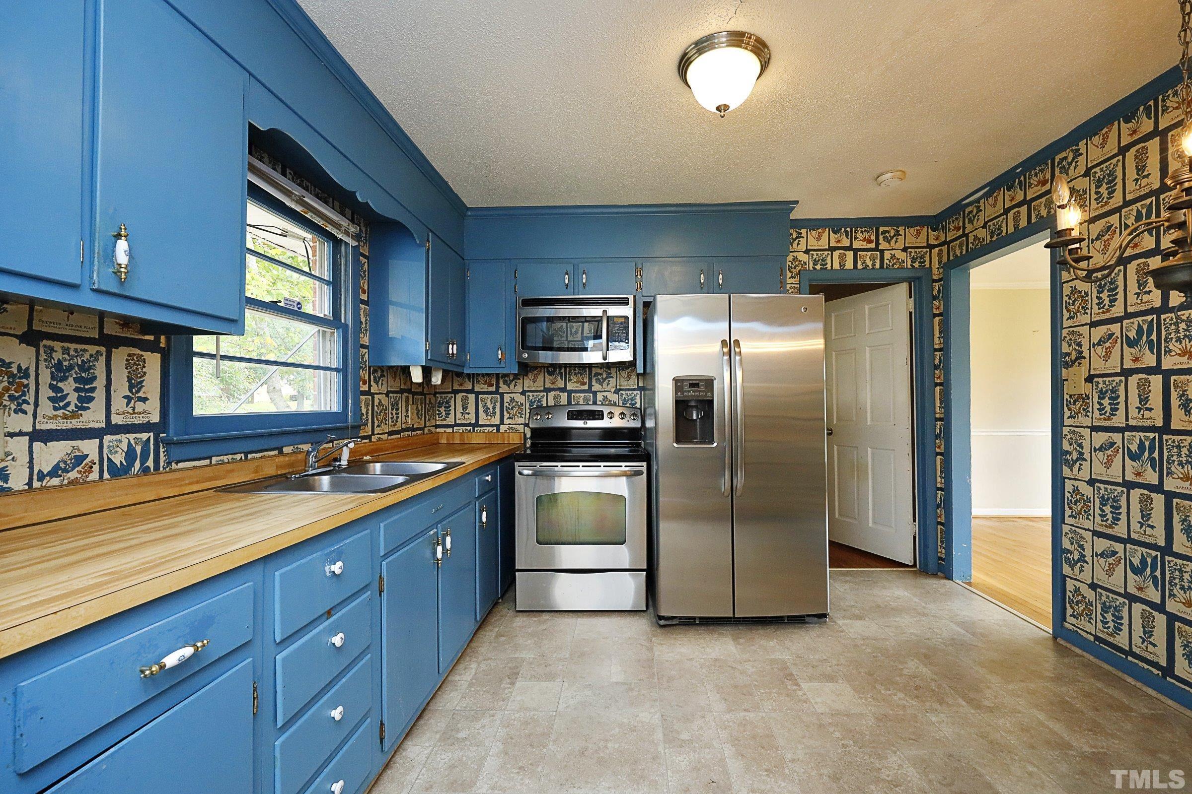 2801 Bromley Street Raleigh, NC 27610 - Photo 8 of 37 a kitchen with stainless steel appliances granite countertop a refrigerator and a sink